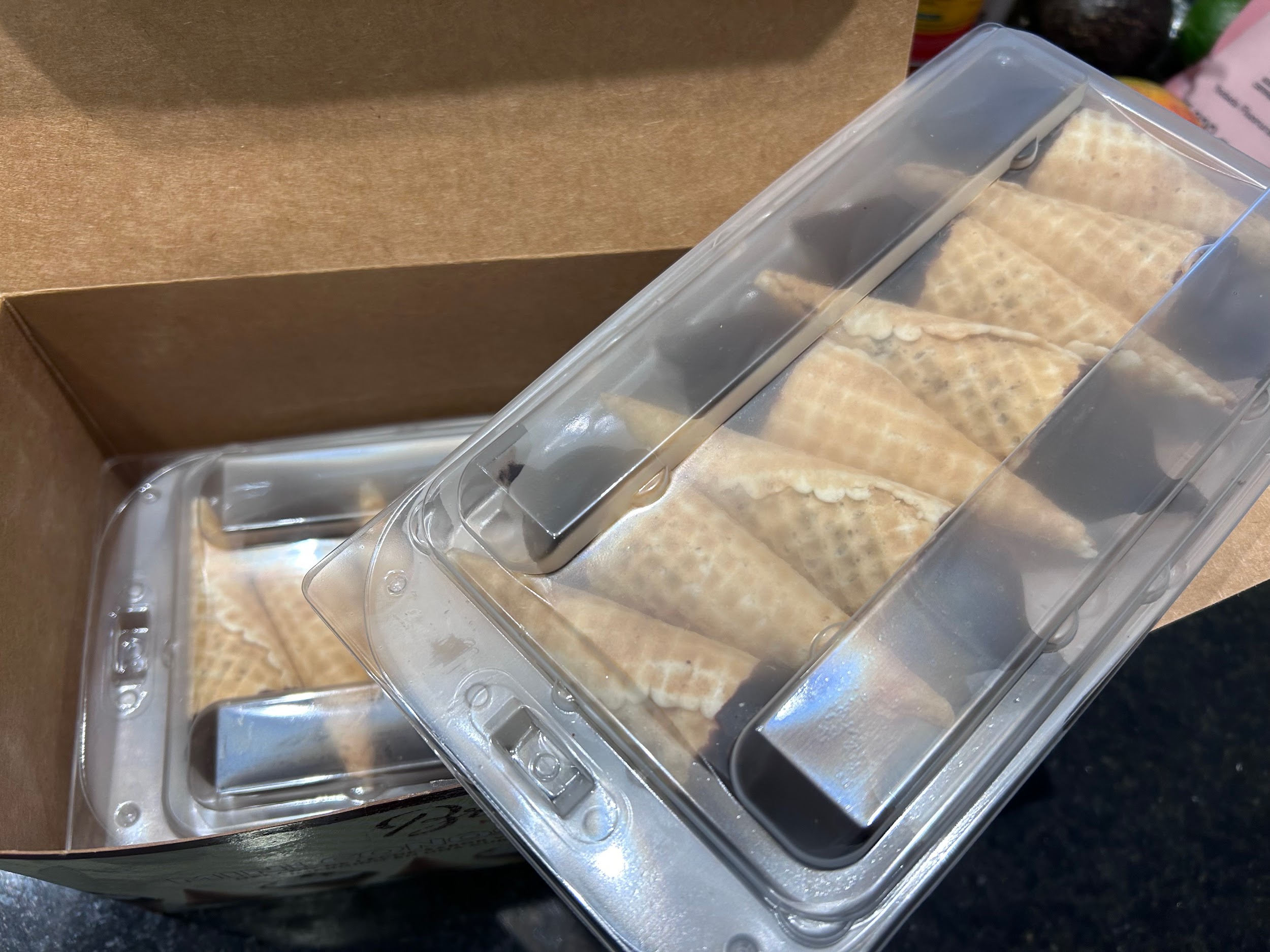 Opened box showing one tray of mini cones inside