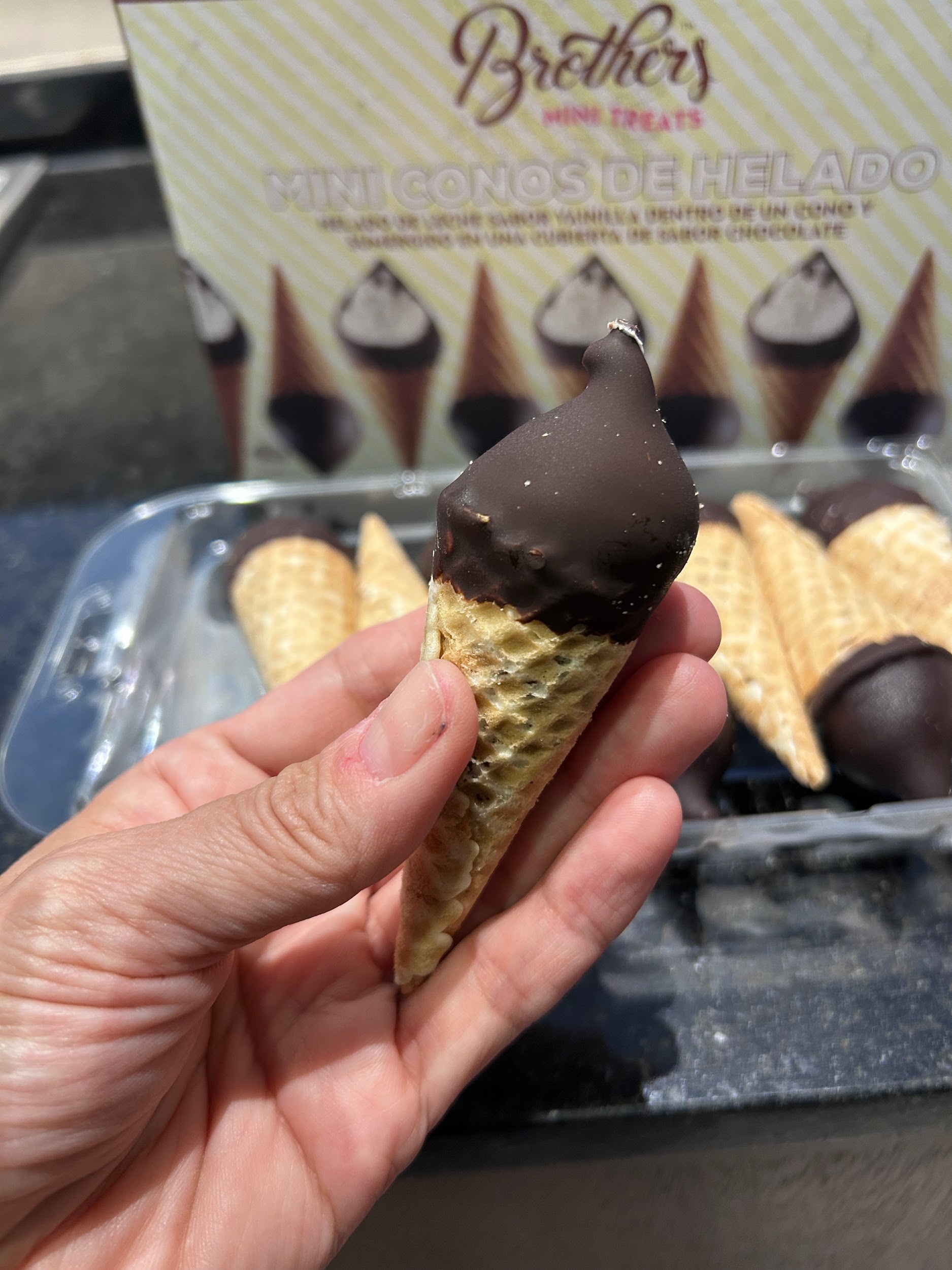 A Brothers mini cone held in hand to show its size