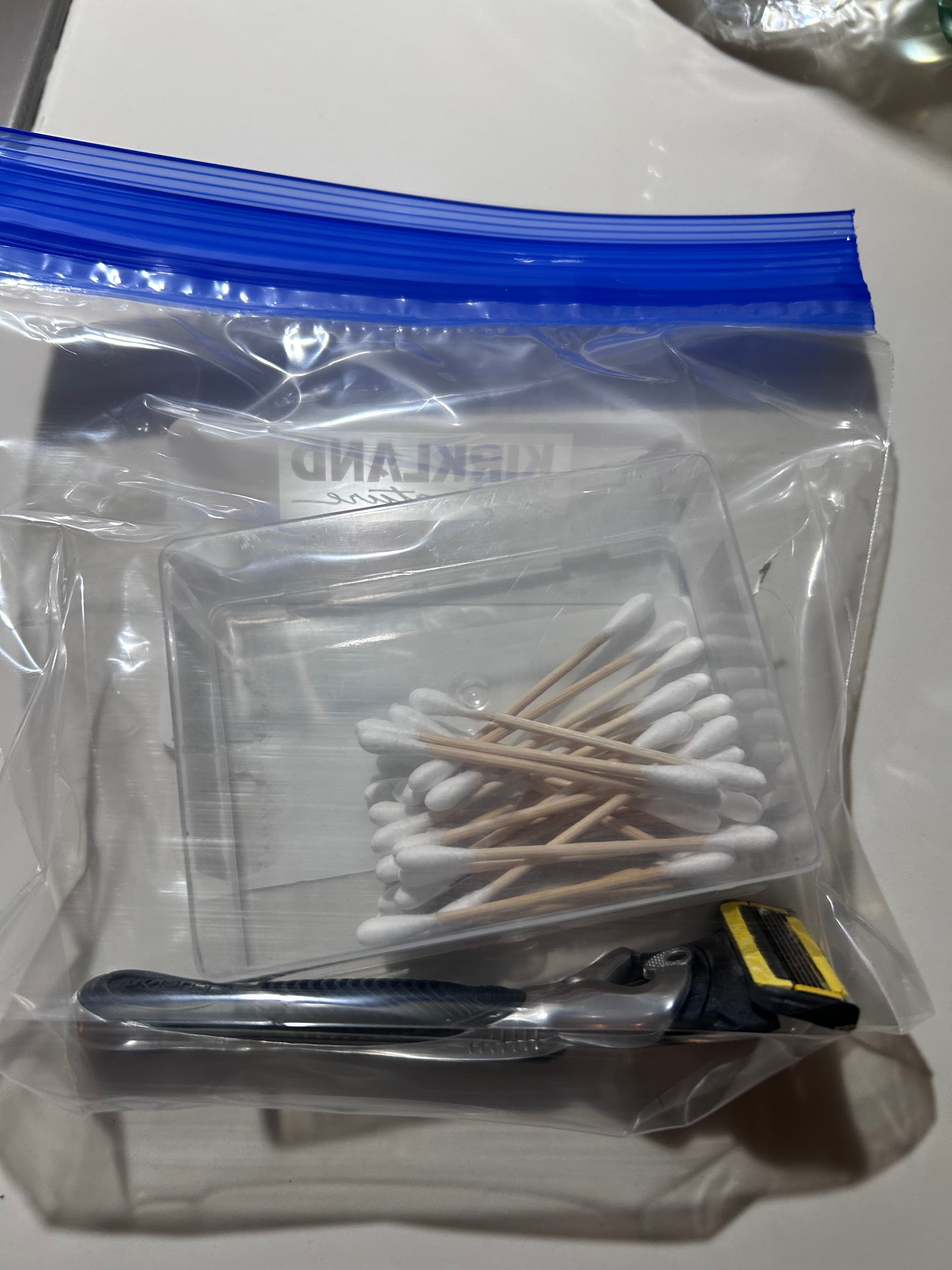 Small travel items stored inside a Kirkland freezer bag